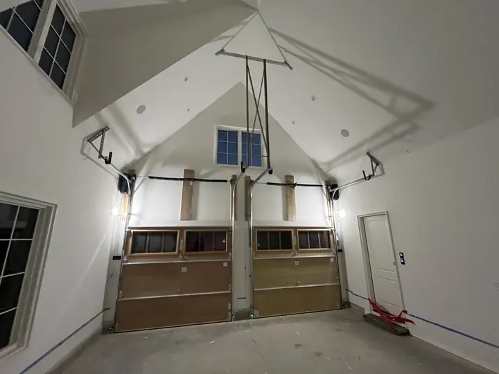 Completed Blackstone installation showing a sectional garage door inside an unfinished garage